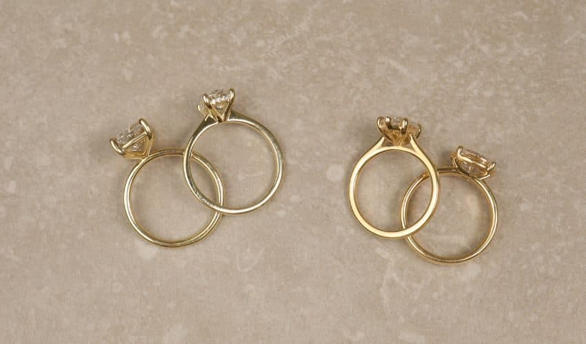 Four yellow gold solitaire engagement rings, shown in pairs
