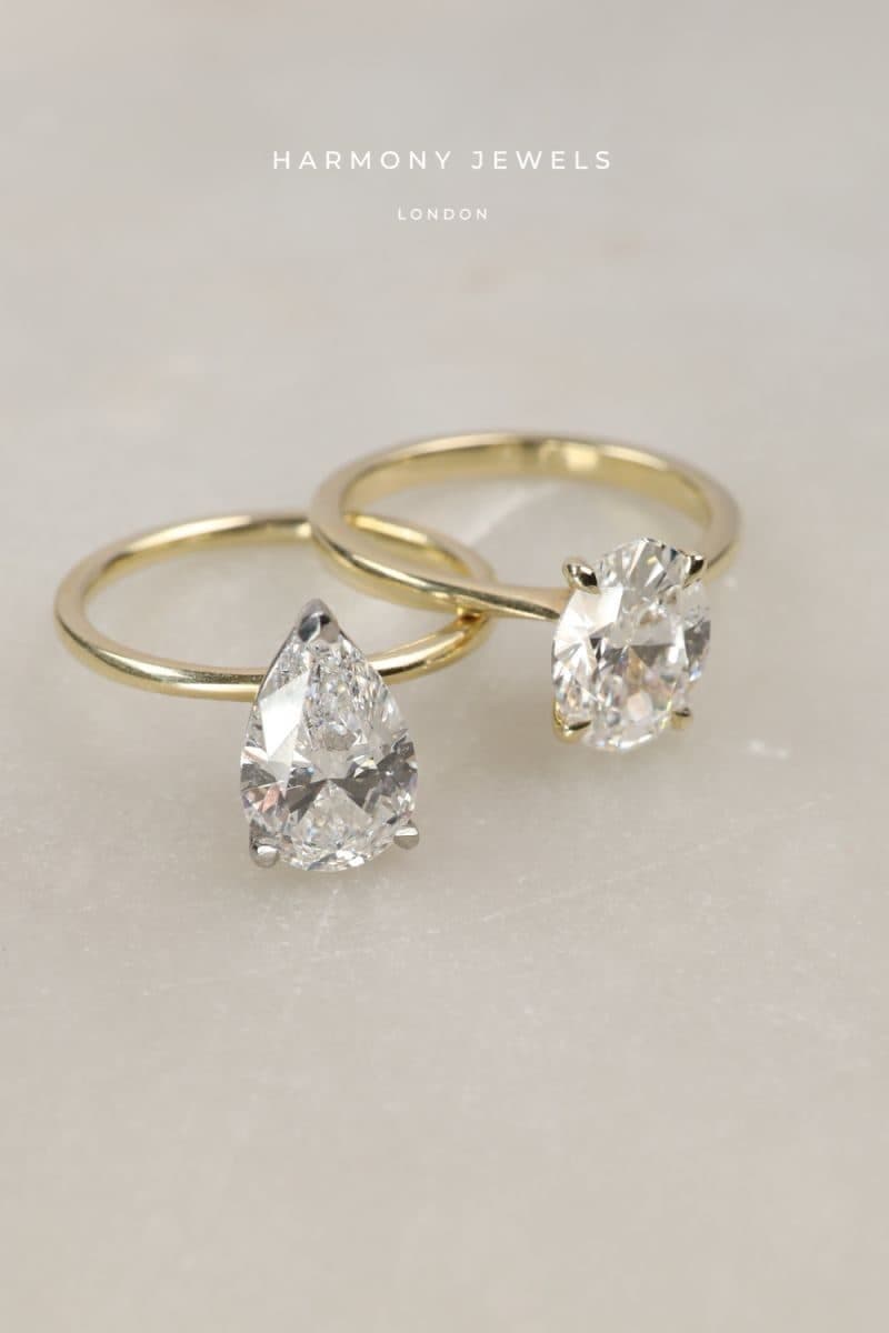 Two pear-shaped diamond solitaires in yellow gold