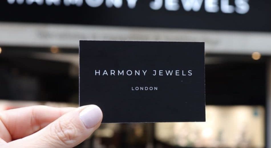 Harmony Jewels London business card held in front of the Hatton Garden showroom