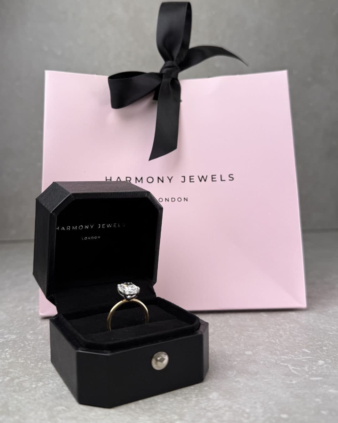 Harmony Jewels ring box and pink gift bag with a diamond engagement ring